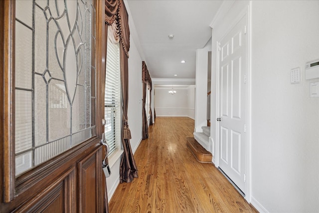 hall featuring a notable chandelier and light hardwood / wood-style floors