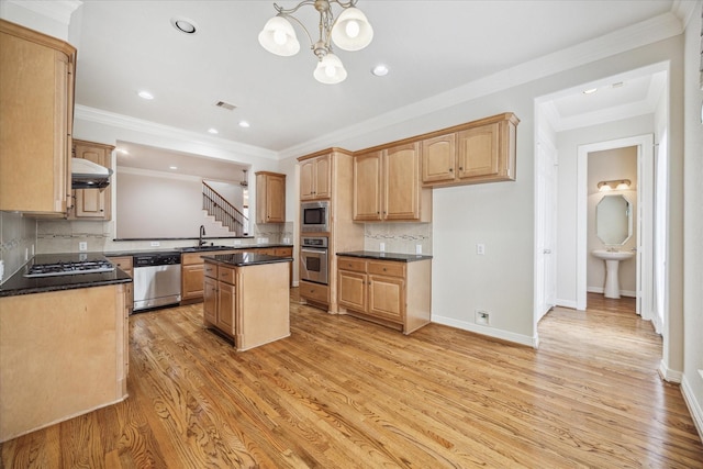 kitchen with tasteful backsplash, a center island, stainless steel appliances, crown molding, and light wood-type flooring