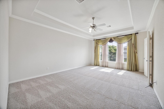 spare room featuring crown molding, light carpet, ceiling fan, and a tray ceiling