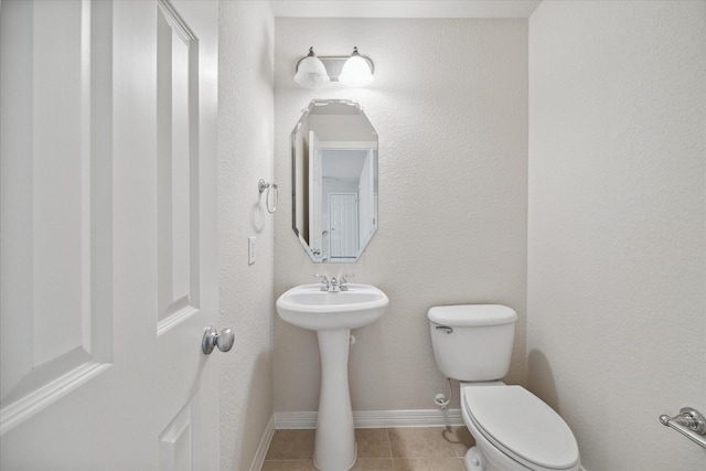 bathroom with tile patterned floors and toilet