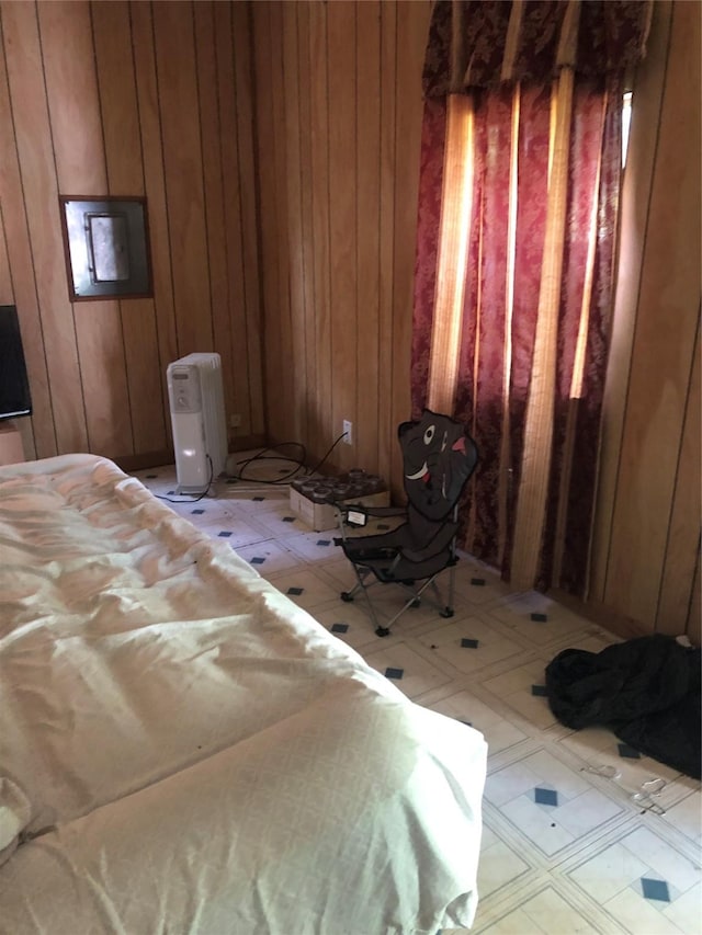 bedroom featuring wooden walls