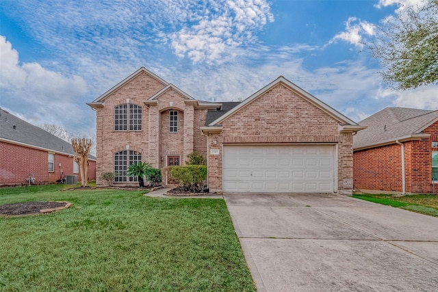 view of property featuring a garage, central air condition unit, and a front lawn