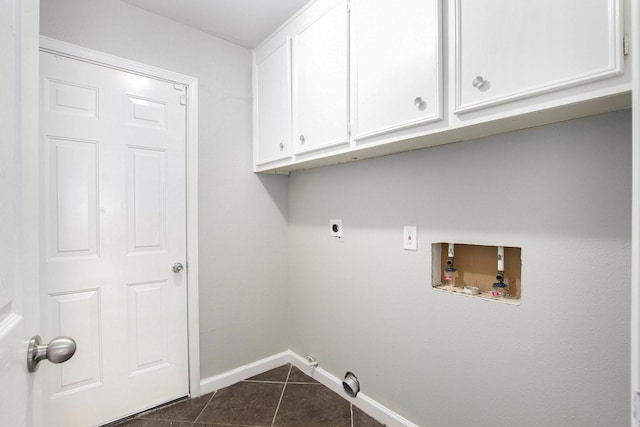 clothes washing area with washer hookup, cabinets, hookup for an electric dryer, and dark tile patterned flooring