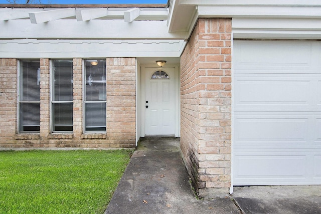 entrance to property with a yard and a garage