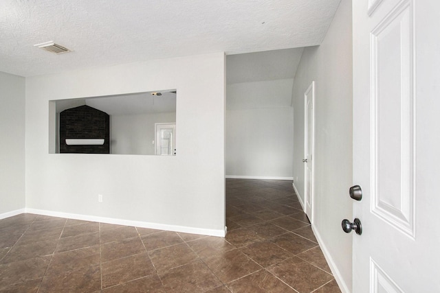 unfurnished room featuring a textured ceiling