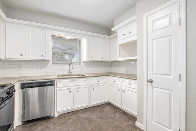 kitchen with sink, white cabinets, decorative backsplash, light stone counters, and stainless steel appliances