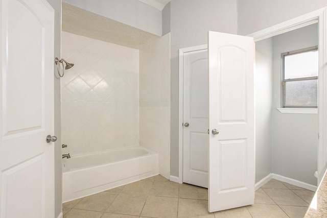 bathroom featuring tiled shower / bath and tile patterned floors