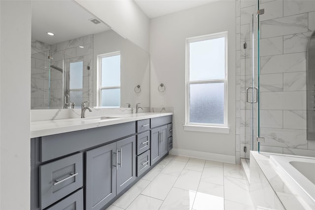 bathroom featuring vanity and independent shower and bath