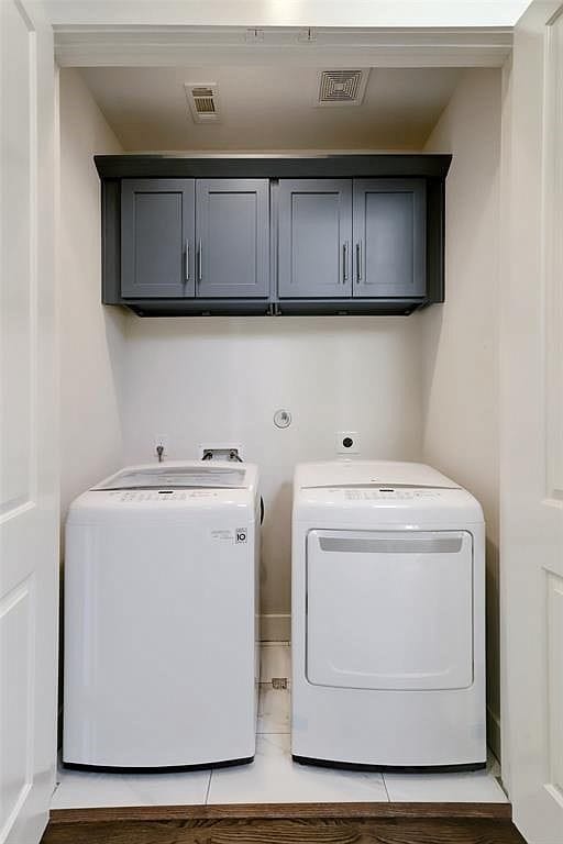 laundry area featuring cabinets and independent washer and dryer