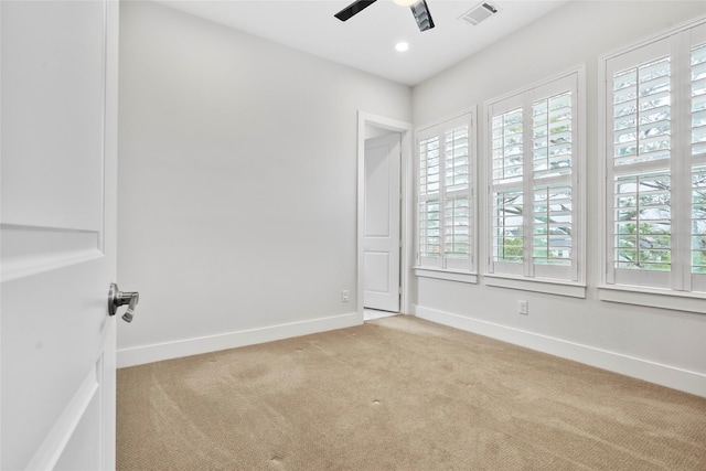 carpeted spare room with ceiling fan and a healthy amount of sunlight