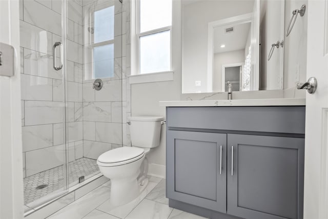 bathroom featuring vanity, an enclosed shower, and toilet