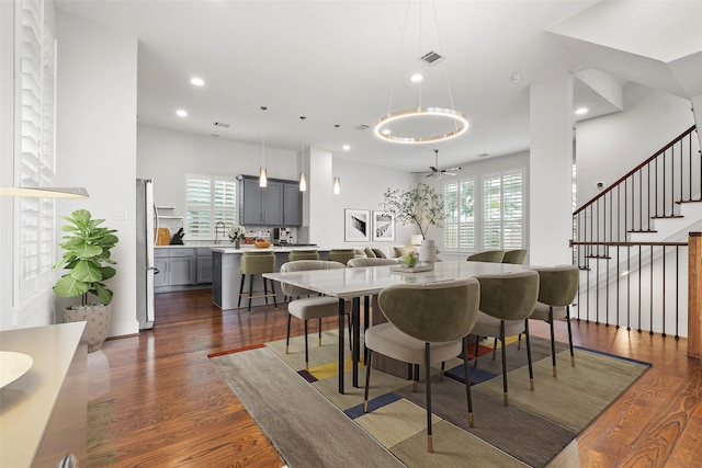 dining space featuring dark wood-type flooring and ceiling fan