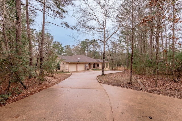 view of front of property with brick siding, driveway, and an attached garage