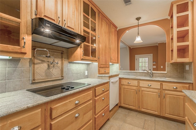 kitchen with glass insert cabinets, light stone countertops, black electric stovetop, under cabinet range hood, and a sink