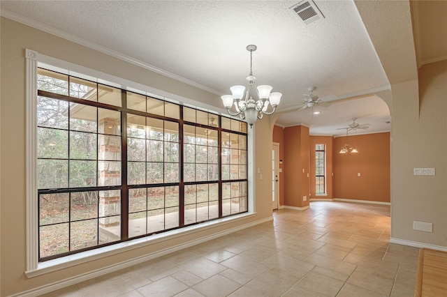 spare room featuring arched walkways, a textured ceiling, and ornamental molding