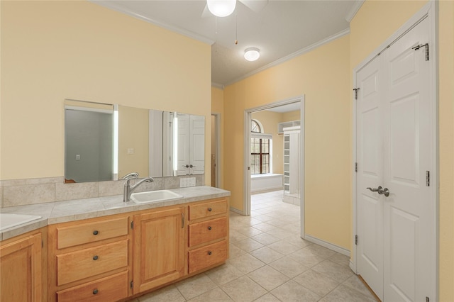 bathroom featuring tile patterned flooring, ornamental molding, baseboards, and vanity