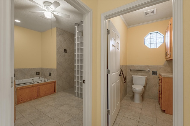 bathroom featuring tile walls, a textured ceiling, a bath, and tile patterned floors