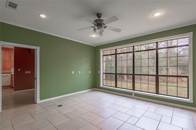 spare room featuring ornamental molding, a wealth of natural light, and visible vents