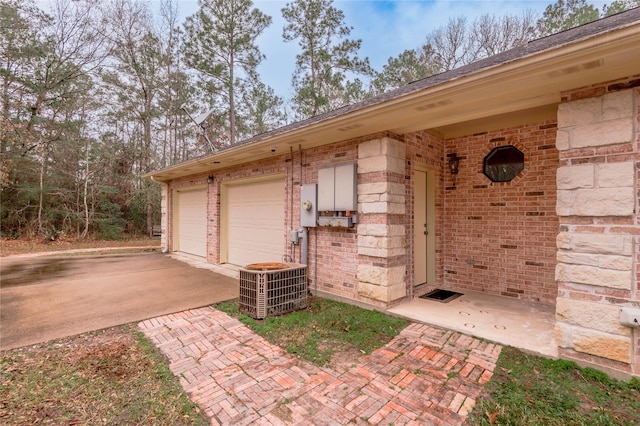 garage featuring cooling unit and concrete driveway