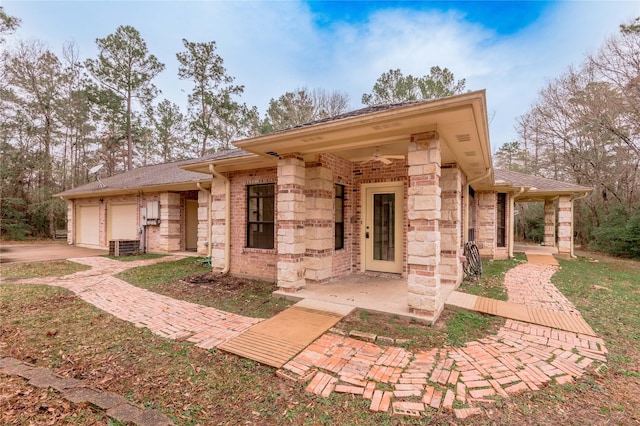 view of front of home featuring a garage and stone siding