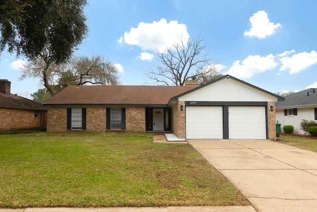 ranch-style house featuring concrete driveway, a chimney, an attached garage, a front yard, and brick siding