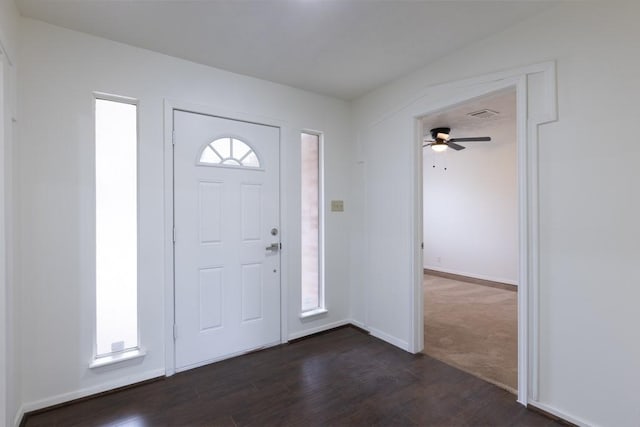 entryway with visible vents, dark wood-type flooring, a wealth of natural light, and baseboards