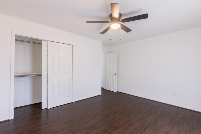 unfurnished bedroom with a closet, a ceiling fan, and dark wood-style flooring