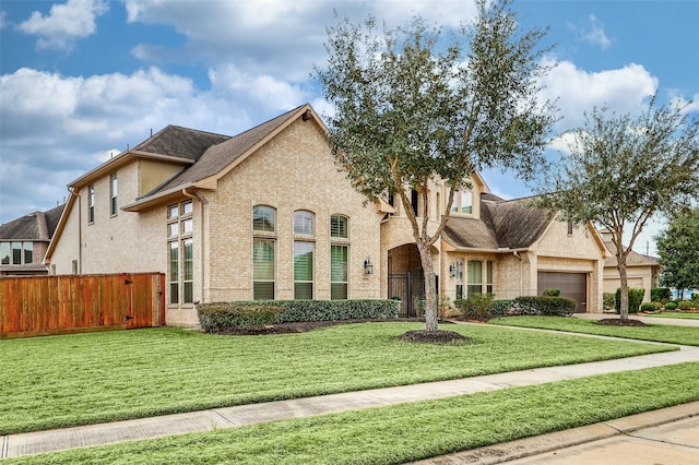 view of front of property with a garage and a front yard