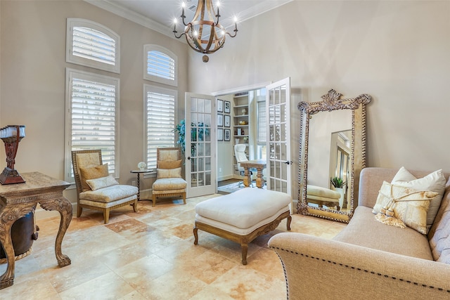 sitting room with ornamental molding, french doors, a chandelier, and a high ceiling