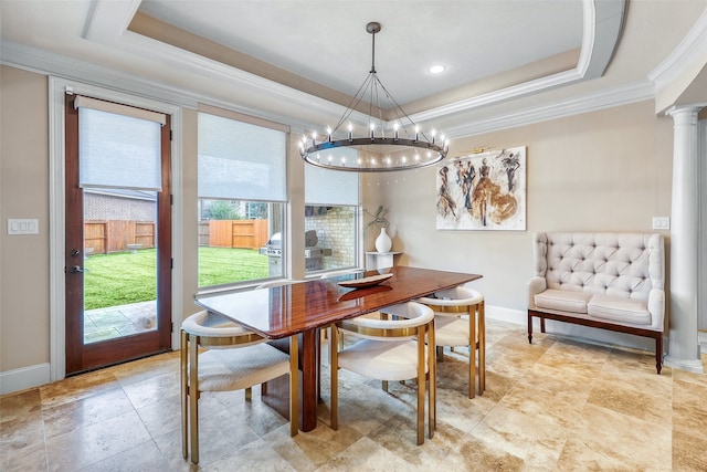 dining area featuring decorative columns, crown molding, a chandelier, and a tray ceiling