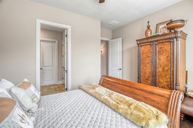 tiled bedroom featuring ceiling fan