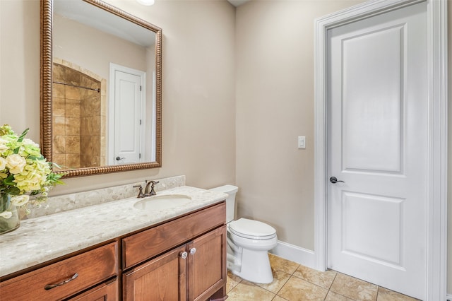 bathroom featuring vanity, a shower, tile patterned floors, and toilet