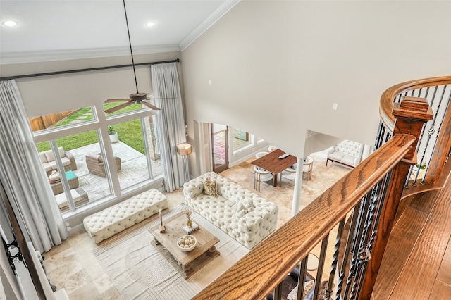 living room with crown molding and ceiling fan