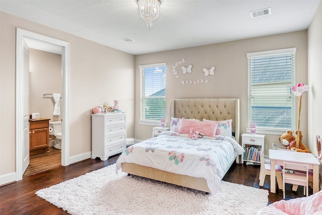 bedroom with connected bathroom and dark hardwood / wood-style flooring