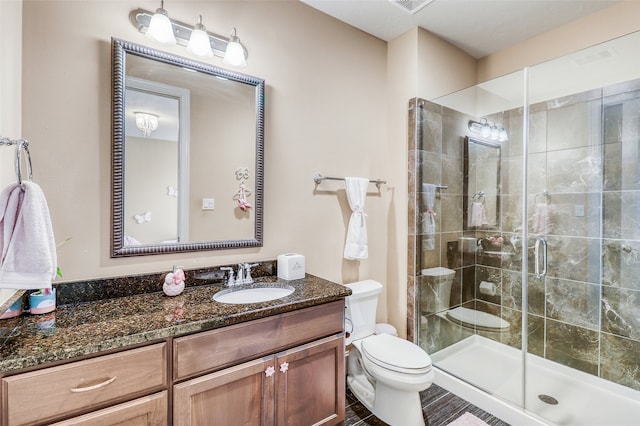 bathroom with vanity, toilet, and walk in shower