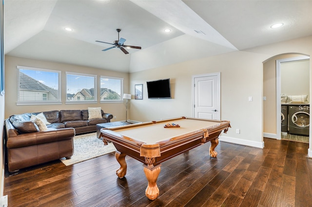 rec room featuring lofted ceiling, dark wood-type flooring, ceiling fan, a tray ceiling, and washing machine and clothes dryer