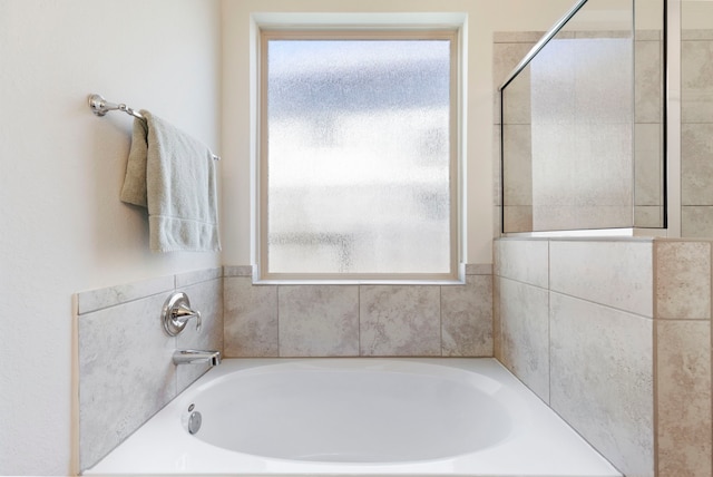 bathroom featuring separate shower and tub