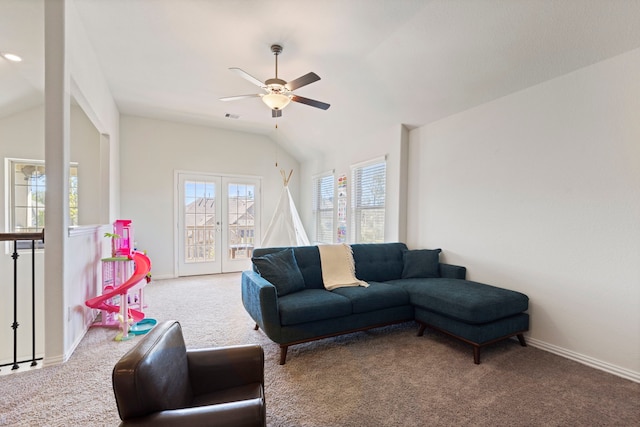 carpeted living room with ceiling fan and lofted ceiling