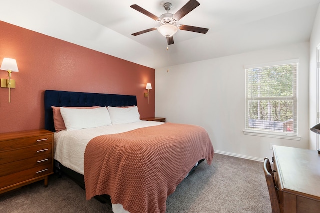 bedroom featuring ceiling fan and dark carpet