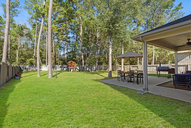 view of yard featuring a patio and a playground