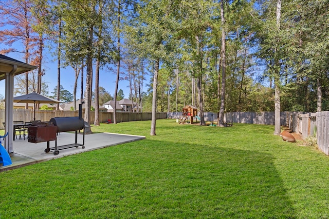 view of yard with a playground and a patio area