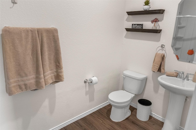 bathroom featuring sink, toilet, and hardwood / wood-style floors