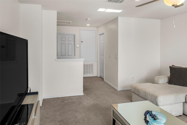 carpeted living room featuring ceiling fan