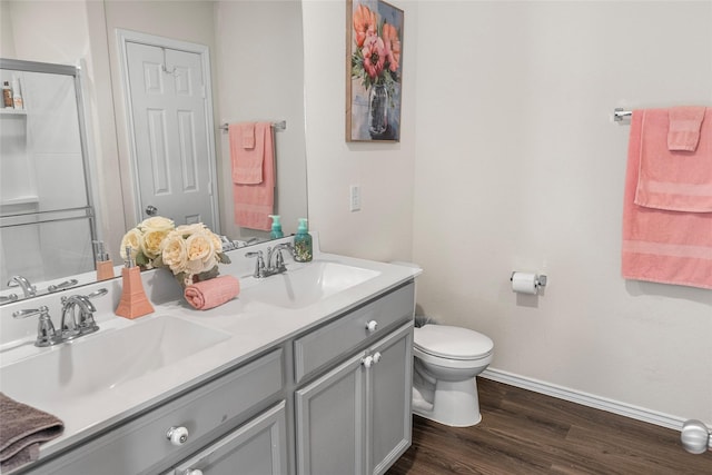 bathroom with hardwood / wood-style flooring, vanity, and toilet