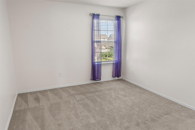 unfurnished room with light colored carpet