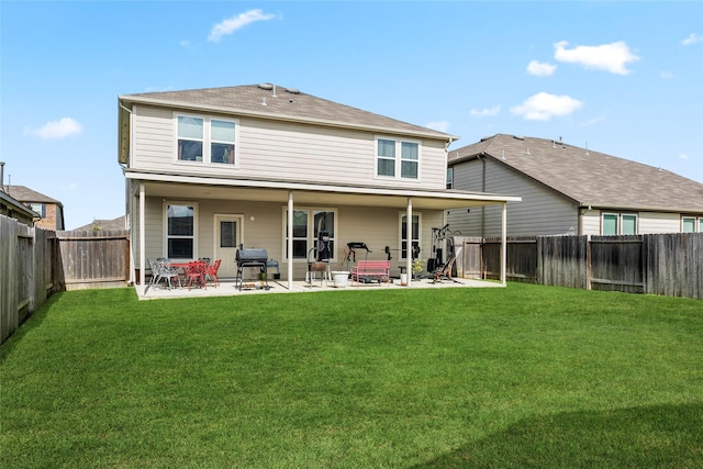 rear view of house with a yard and a patio area