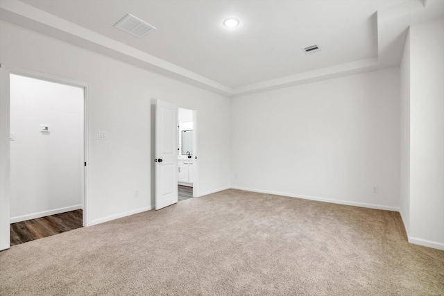 113 County Road 645, Kenefick, TX 77535 - spare room featuring dark colored carpet and a tray ceiling