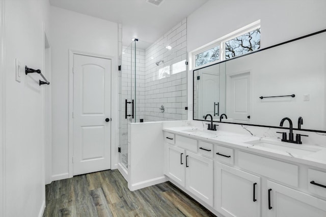 113 County Road 645, Kenefick, TX 77535 - bathroom with vanity, hardwood / wood-style floors, and a shower with door