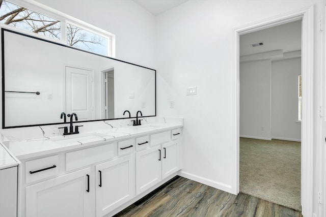 113 County Road 645, Kenefick, TX 77535 - bathroom with vanity and wood-type flooring