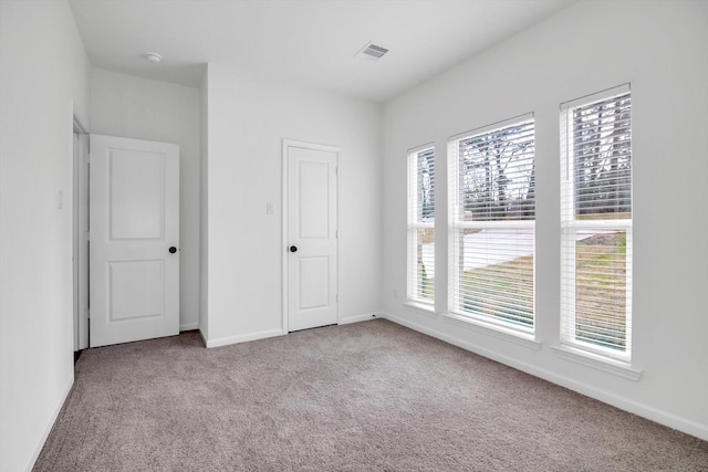 113 County Road 645, Kenefick, TX 77535 - unfurnished bedroom featuring light carpet